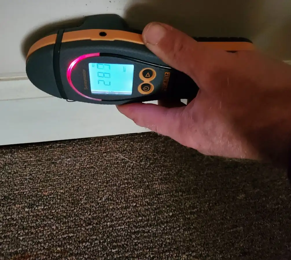 Moisture detection at baseboard during Storm Damage Restoration in Commerce City